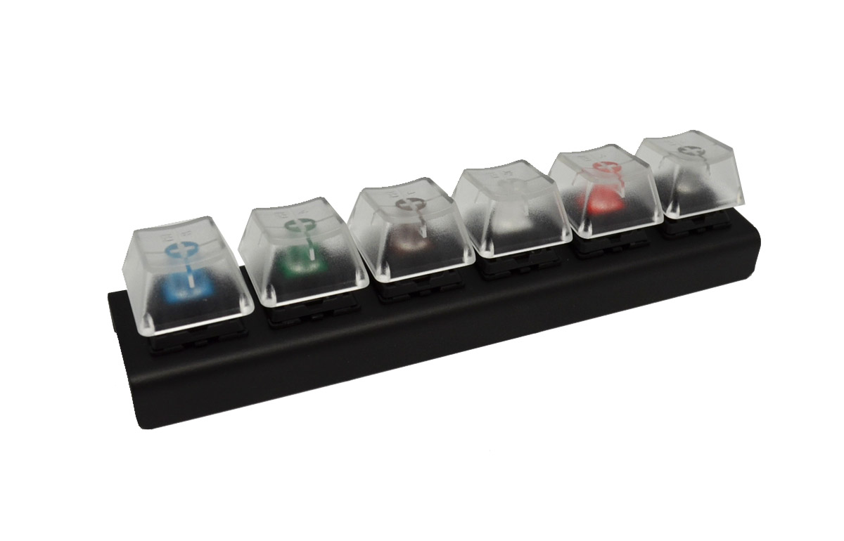 a "switch tester" made of six keys in a row mounted on a plastic bar, each using a different color (kind) of Cherry MX switch