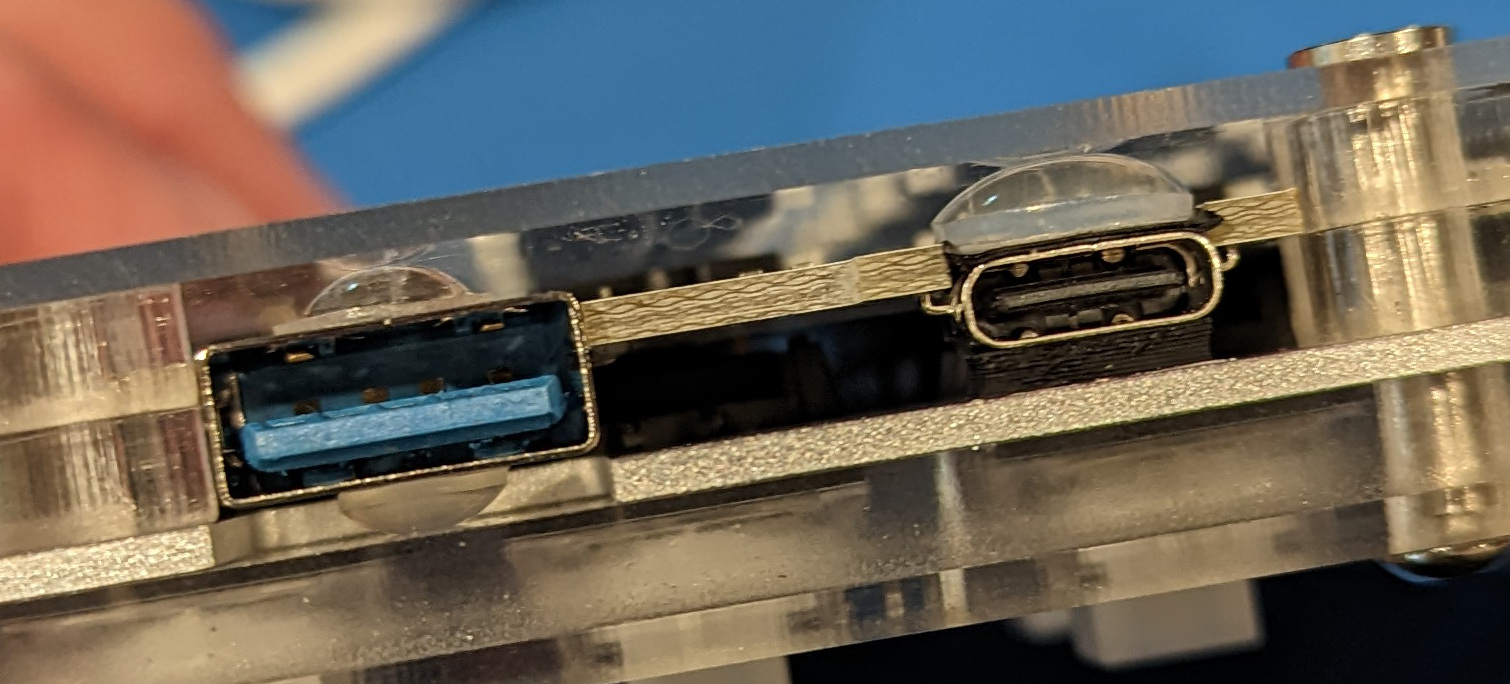 USB-A and USB-C connectors, braced against case with bumpons and electrical tape