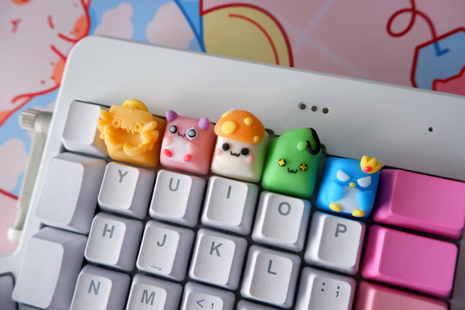 close-up photo of custom keycaps that are shaped like 3D renderings of Maplestory characters